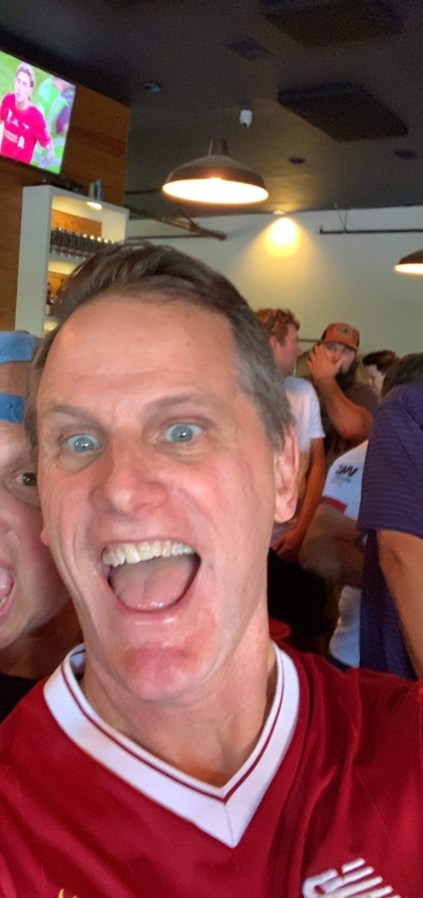 Jimmy in a Liverpool jersey, mid-celebration