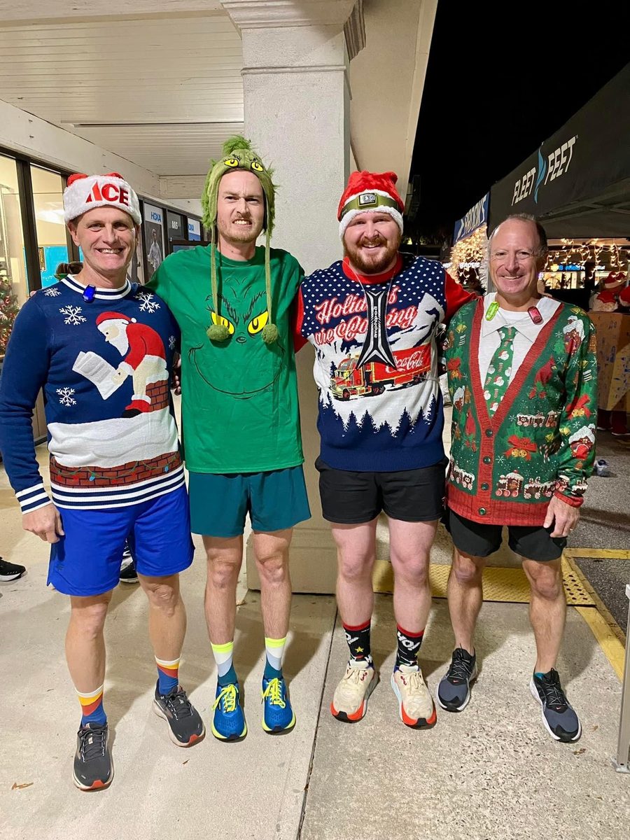 Jimmy and three friends in ugly holiday sweaters before a run